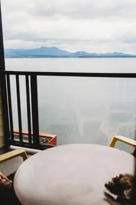 a table and chairs with a view of the ocean at The Oceanfront Hotel in Sointula