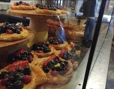 a display case in a bakery with different types of pastries at Ski-in Ski-out at upper village next to Fairmount Hotel In Whistler in Whistler