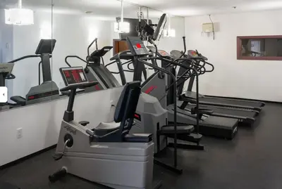 a gym with several cardio machines in a room at Ski-in Ski-out at upper village next to Fairmount Hotel In Whistler in Whistler