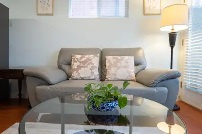 a living room with a couch and a glass table at Lovely 1BR Secondary suite with Separate entrance in New Westminster