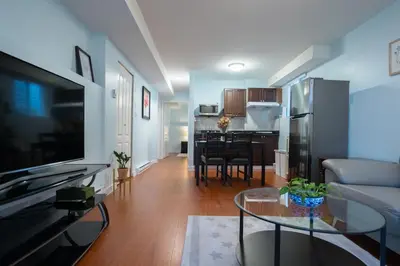 a living room with a couch and a table at Lovely 1BR Secondary suite with Separate entrance in New Westminster