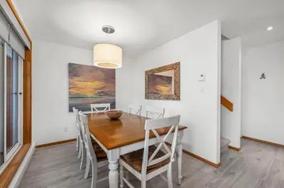 a dining room with a wooden table and chairs at 3BR in Whistler Creek Ridge, Ski In, Ski Out, Private Hot Tub, Wood Burning Fireplace, Private Garage in Whistler