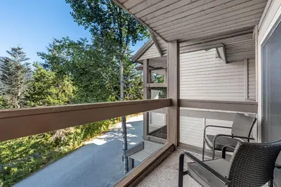 a balcony with a table and chairs on a house at 3BR in Whistler Creek Ridge, Ski In, Ski Out, Private Hot Tub, Wood Burning Fireplace, Private Garage in Whistler