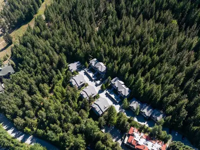 an aerial view of a house in a forest at 3BR in Whistler Creek Ridge, Ski In, Ski Out, Private Hot Tub, Wood Burning Fireplace, Private Garage in Whistler