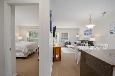 a bedroom with a bed and a desk in a room at 1BR in The Aspens, King Bed, True Ski In, Ski Out, Hot Tubs and Pool, Ski Valet, Private Balcony in Whistler