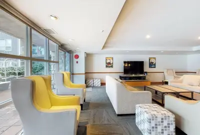 a living room with couches and a tv at 1BR in The Aspens, King Bed, True Ski In, Ski Out, Hot Tubs and Pool, Ski Valet, Private Balcony in Whistler