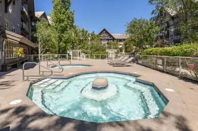 a small swimming pool in the middle of a courtyard at 1BR in The Aspens, King Bed, True Ski In, Ski Out, Hot Tubs and Pool, Ski Valet, Private Balcony in Whistler