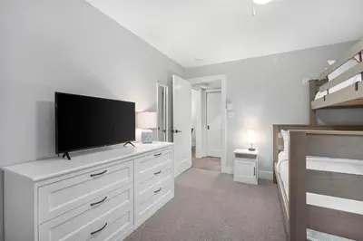 a bedroom with a flat screen tv on a dresser at 2BR in Snowberry, Wood Burning Fireplace, Modern Finishes, Parking, Ski Hill Shuttle in Whistler