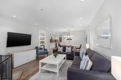 a living room with a couch and a tv at 2BR in Snowberry, Wood Burning Fireplace, Modern Finishes, Parking, Ski Hill Shuttle in Whistler