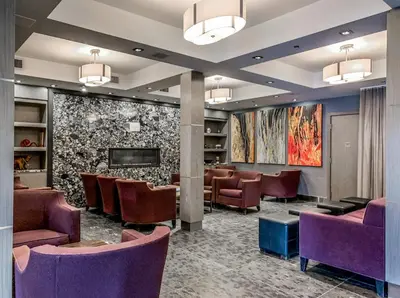 a waiting room at a hospital with purple chairs at Newly renovated Blue Sky - Family Fun - 2 Bed -2 Bath in Canmore