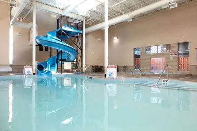 a indoor swimming pool with a blue water slide at Newly renovated Blue Sky - Family Fun - 2 Bed -2 Bath in Canmore