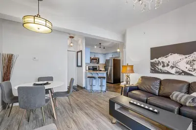 a living room with a couch and a table at Newly renovated Blue Sky - Family Fun - 2 Bed -2 Bath in Canmore