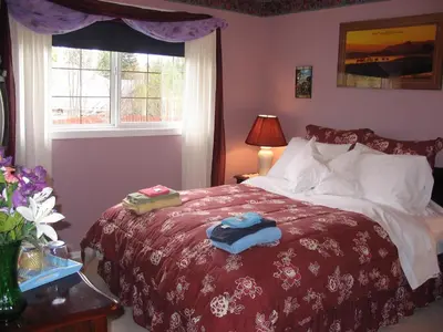 a bedroom with a bed with two towels on it at The Grateful Bed B'n'B in Prince George