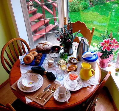 a wooden table with food and drinks on it at The Grateful Bed B'n'B in Prince George