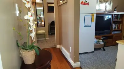 a living room with a refrigerator and a tv at The Grateful Bed B'n'B in Prince George