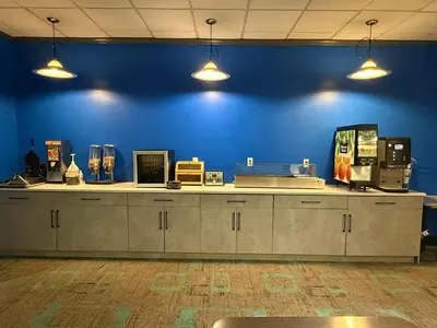 a room with a blue wall and a counter at Days Inn by Wyndham Drayton Valley in Drayton Valley