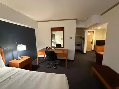a hotel room with a desk and a bed at Days Inn by Wyndham Drayton Valley in Drayton Valley