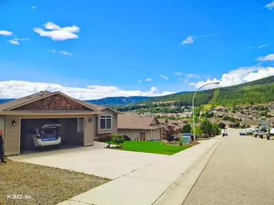 a house with a car parked on the garage at 1 bedroom lake Mountain view in West Kelowna