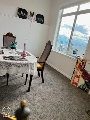 a room with a table and a chair and a window at 1 bedroom lake Mountain view in West Kelowna