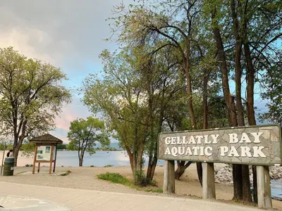 a park sign in front of a body of water at 1 bedroom lake Mountain view in West Kelowna