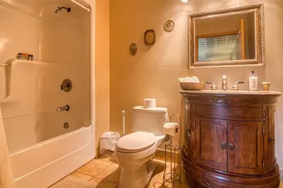 a bathroom with a toilet and a shower and a sink at Pine Ridge, Log Home with Lake View and Backyard in Invermere