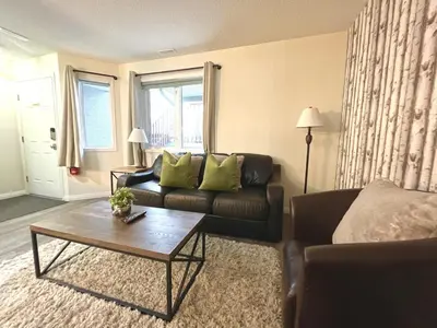 a living room with a couch and a coffee table at Nakiska, 2 Bed 1 Bath with Mtn Views in Canmore