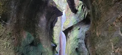 a waterfall in a cave in a canyon at Halibut Hideaway in Port Renfrew