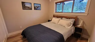 a bed in a bedroom with a window and a bed sidx sidx sidx at Halibut Hideaway in Port Renfrew