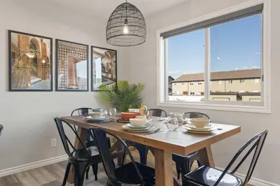 a dining room with a wooden table and chairs at The Saturday I Perfect for Families I Arcade Games in Sylvan Lake