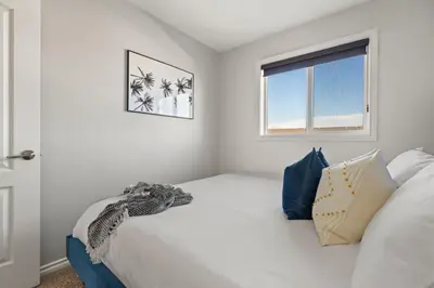 a bedroom with a large white bed with a window at The Saturday I Perfect for Families I Arcade Games in Sylvan Lake