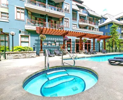 a large swimming pool in front of a building at Alpenglow Lodge Fika One Bedroom by MVA in Whistler