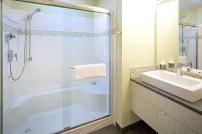 a bathroom with a shower and a sink at Mariner's Loft - Salt Spring Island in Ganges