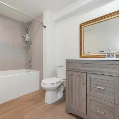 a bathroom with a sink and a toilet and a mirror at Hidden Oasis in Victoria, BC in Victoria