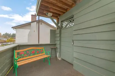 a bench sitting on the side of a building at Hidden Oasis in Victoria, BC in Victoria