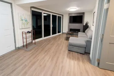 a living room with a couch and a chair at Hidden Oasis in Victoria, BC in Victoria