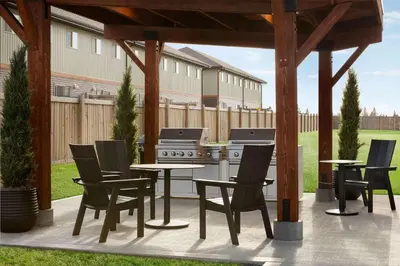 a patio with a table and chairs and a stove at Microtel Inn & Suites by Wyndham Lloydminster in Lloydminster