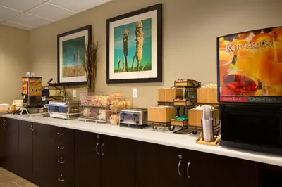 a room with a counter top with a television and appliances at Microtel Inn & Suites by Wyndham Lloydminster in Lloydminster