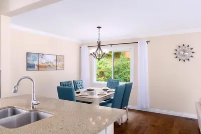 a kitchen and dining room with a table and chairs at LOVELY 3 bedroom PORT MOODY spacious home 6 people free parking in Port Moody