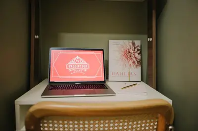 a laptop computer sitting on top of a table at The Garden Room at Waddington Flats in Victoria