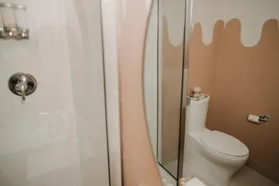 a bathroom with a toilet and a glass shower at The Garden Room at Waddington Flats in Victoria
