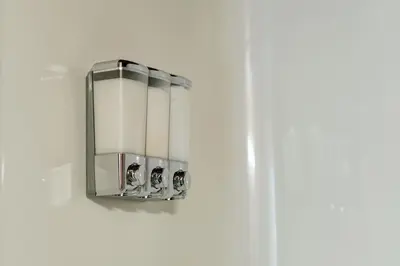 a light fixture hanging on a white wall at Victoria's Parliamentary Suite with Private Rooftop Patio & Harbour View in Victoria