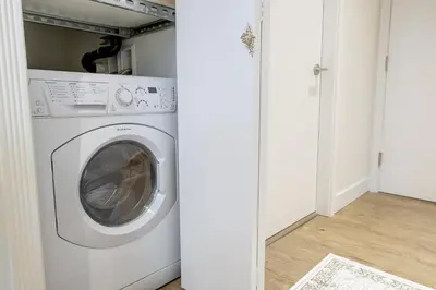 a laundry room with a washer and dryer at Victoria's Parliamentary Suite with Private Rooftop Patio & Harbour View in Victoria