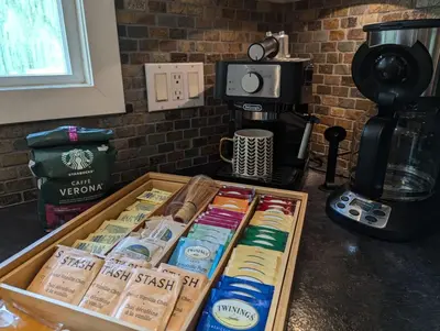 a box filled with different types of food next to a coffee maker at Waterfront Oasis with Pool, Hot Tub & Pet Friendly in Kelowna