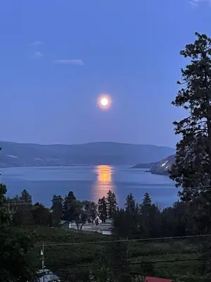 a full moon rising over a body of water at Lakeview Gardens B&B in Peachland