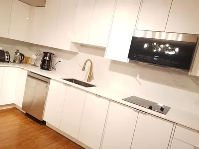 a white kitchen with a sink and a microwave at JESI'S NEW HOUSE, Self Enter 2BR, Whole Suite, Close to White Rock Beach & US Border in Surrey