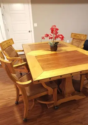 a wooden table with chairs and a potted plant on it at JESI'S NEW HOUSE, Self Enter 2BR, Whole Suite, Close to White Rock Beach & US Border in Surrey