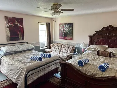 a bedroom with two beds and a ceiling fan at B&B In Fraser Valley in Abbotsford