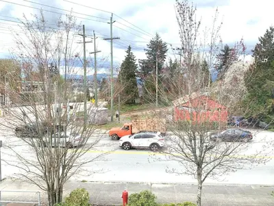 a truck and a car parked in a parking lot at B&B In Fraser Valley in Abbotsford