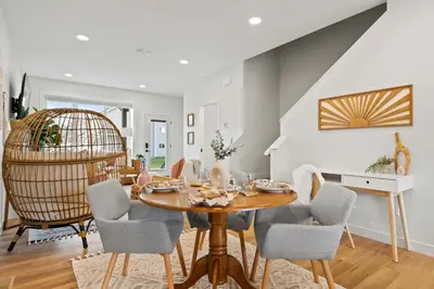 a dining room with a table and chairs at The Promenade I Patio and BBQ I Fire pit I Sleep 9 in Sylvan Lake