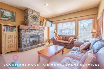 a living room with a couch and a fireplace at Bear's Paw Chalet - Amazing Location & Ski In-Out in Big White